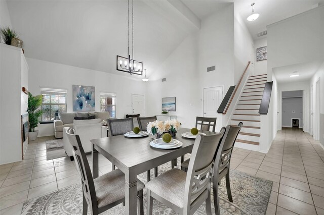 1121 Basswood Ln, Royse City, TX 75189 - dining space with high vaulted ceiling, an inviting chandelier, stairway, and light tile patterned floors