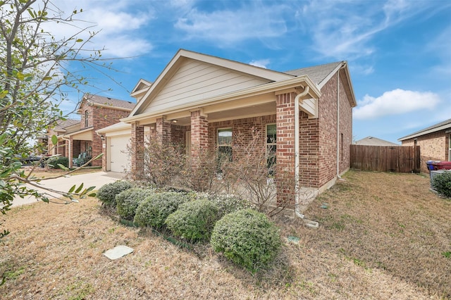 1121 Basswood Ln, Royse City, TX 75189 - view of side of property with fence, concrete driveway, an attached garage, a lawn, and brick siding