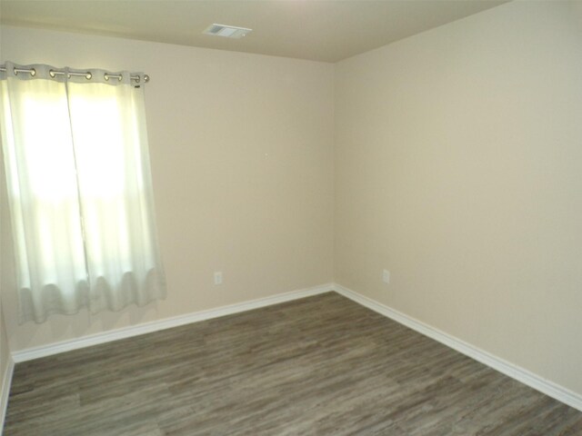18287 County Road 4001, Mabank, TX 75147 - empty room with dark wood-type flooring, healthy amount of natural light, and baseboards