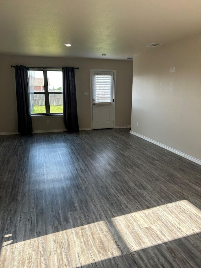 18287 County Road 4001, Mabank, TX 75147 - unfurnished living room featuring dark wood-style flooring and baseboards