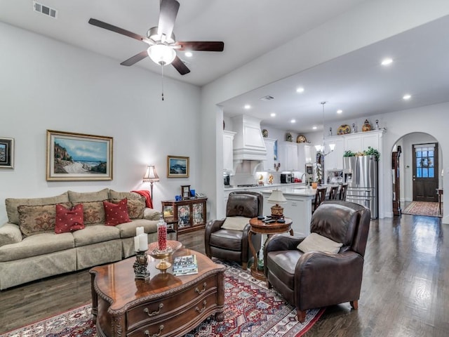 living room with visible vents, a ceiling fan, dark wood finished floors, recessed lighting, and arched walkways