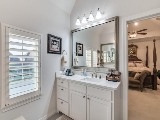 ensuite bathroom featuring ensuite bath, vanity, lofted ceiling, and a ceiling fan
