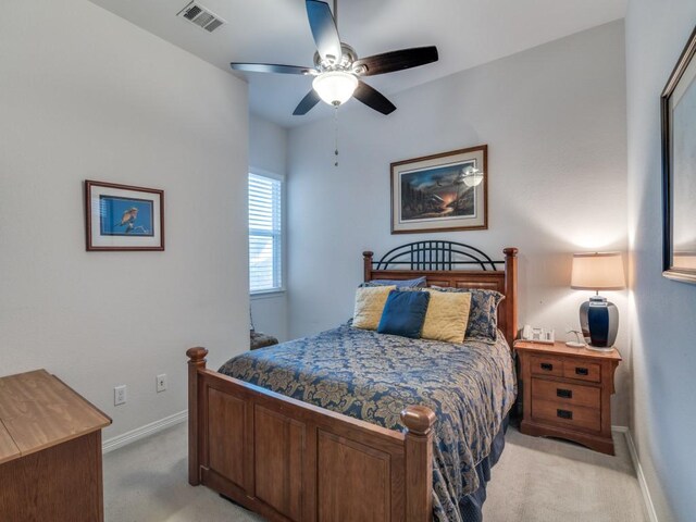 bedroom with light carpet, visible vents, ceiling fan, and baseboards