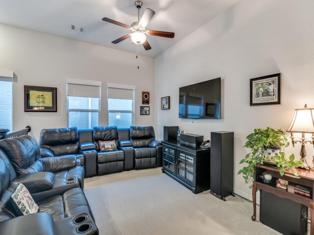 living room featuring visible vents, baseboards, light colored carpet, and a ceiling fan
