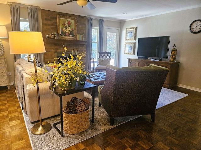 living room featuring baseboards, ceiling fan, and ornamental molding