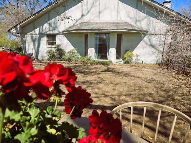 rear view of property featuring brick siding