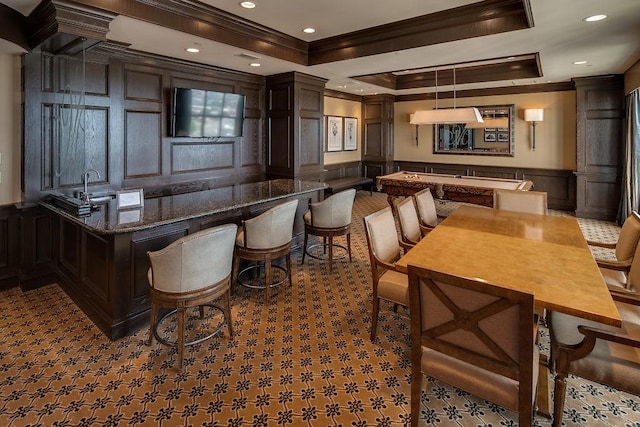 3401 Lee Pkwy Unit 3A, Dallas, TX 75219 - bar with a decorative wall, crown molding, a tray ceiling, a sink, and wainscoting