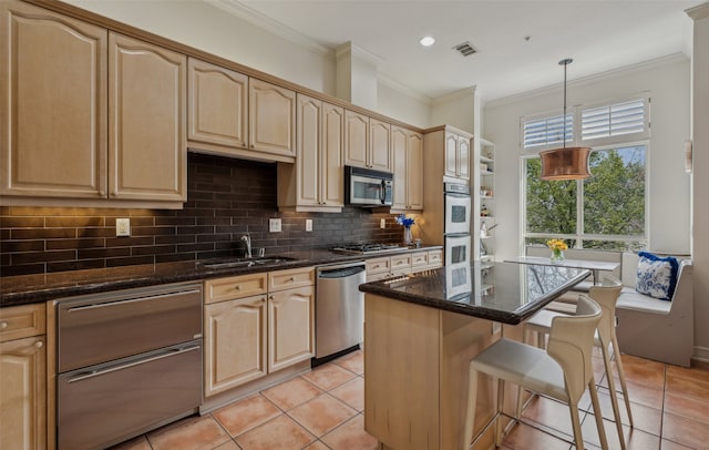 3401 Lee Pkwy Unit 3A, Dallas, TX 75219 - kitchen with stainless steel appliances, a sink, a kitchen bar, dark stone countertops, and ornamental molding