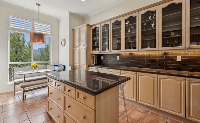 3401 Lee Pkwy Unit 3A, Dallas, TX 75219 - kitchen featuring light tile patterned floors, tasteful backsplash, glass insert cabinets, a kitchen bar, and light brown cabinets