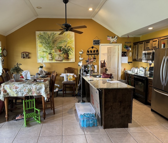 kitchen with light tile patterned floors, stainless steel appliances, ceiling fan, and lofted ceiling