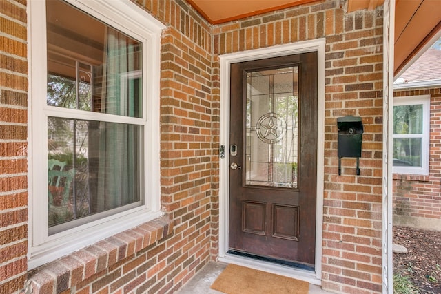 property entrance with brick siding