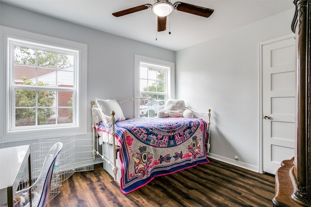 bedroom featuring ceiling fan, visible vents, baseboards, and wood finished floors