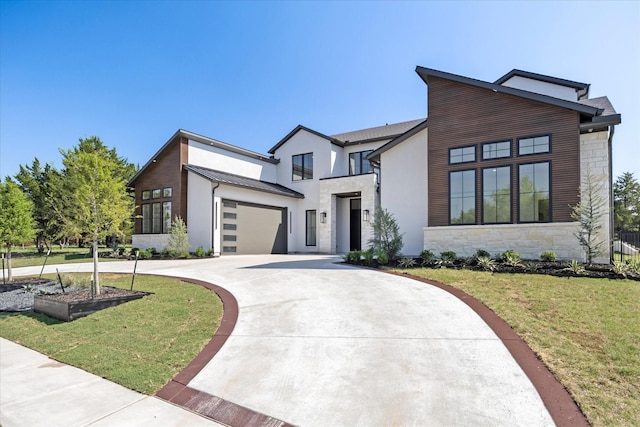 contemporary home featuring driveway, stone siding, metal roof, a front lawn, and a standing seam roof
