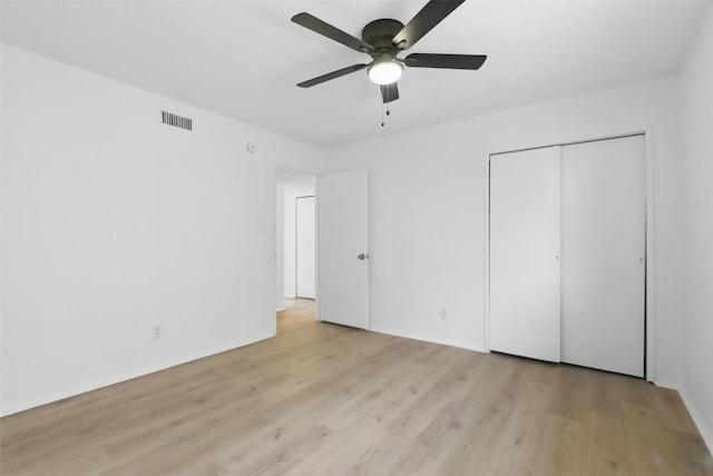 1329 Steinburg Ln, Fort Worth, TX 76134 - unfurnished bedroom with visible vents, a ceiling fan, a closet, and light wood-style floors