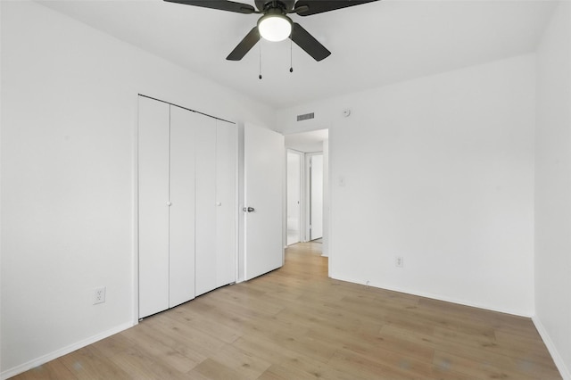 1329 Steinburg Ln, Fort Worth, TX 76134 - unfurnished bedroom with visible vents, baseboards, a closet, a ceiling fan, and light wood finished floors