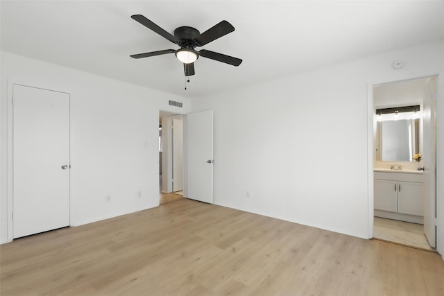 1329 Steinburg Ln, Fort Worth, TX 76134 - unfurnished bedroom featuring visible vents, light wood-type flooring, a sink, and ensuite bathroom