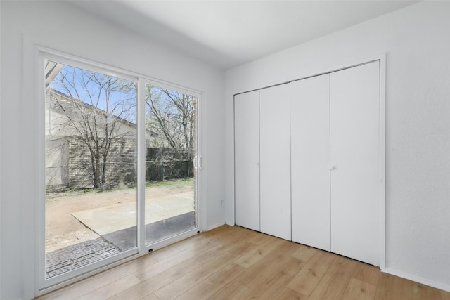 1329 Steinburg Ln, Fort Worth, TX 76134 - unfurnished bedroom featuring baseboards, access to outside, and wood finished floors