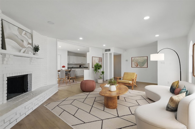 1329 Steinburg Ln, Fort Worth, TX 76134 - living room featuring visible vents, recessed lighting, light wood finished floors, and a brick fireplace