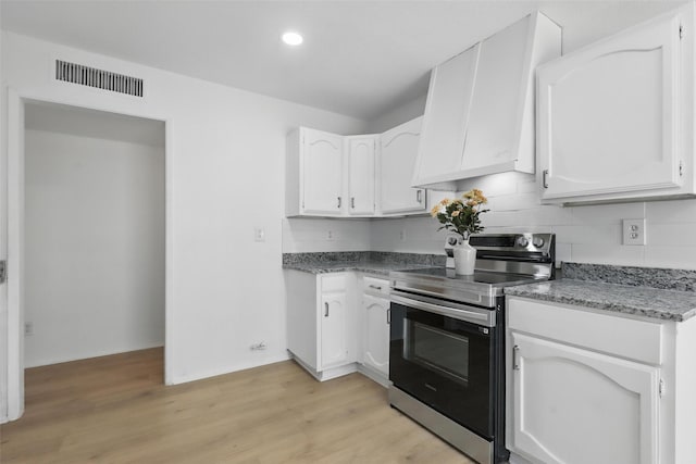 1329 Steinburg Ln, Fort Worth, TX 76134 - kitchen featuring custom range hood, visible vents, white cabinets, and electric range