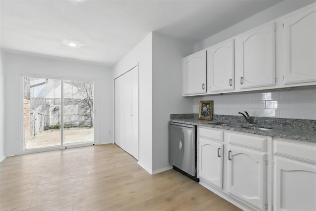 1329 Steinburg Ln, Fort Worth, TX 76134 - kitchen featuring dark stone countertops, light wood-style flooring, white cabinets, a sink, and stainless steel dishwasher