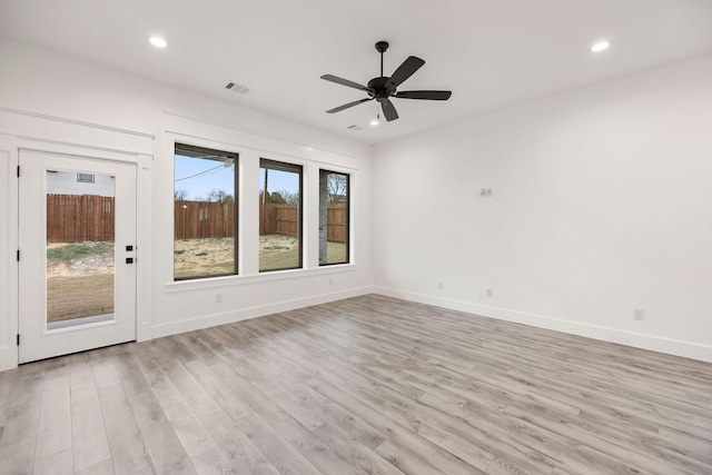 spare room featuring light wood-style flooring and recessed lighting
