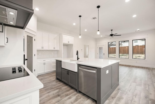 kitchen with a ceiling fan, a sink, decorative backsplash, dishwasher, and black electric stovetop