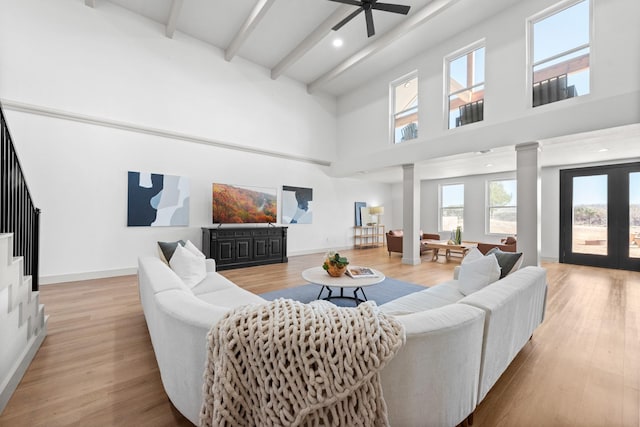 3508 Sentinel Oak Dr, Flower Mound, TX 75022 - living room with beamed ceiling, decorative columns, and wood finished floors