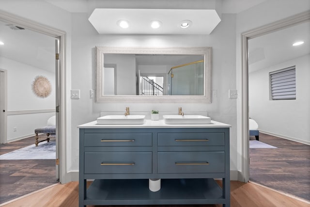 3508 Sentinel Oak Dr, Flower Mound, TX 75022 - full bath featuring double vanity, wood finished floors, a shower stall, and a sink