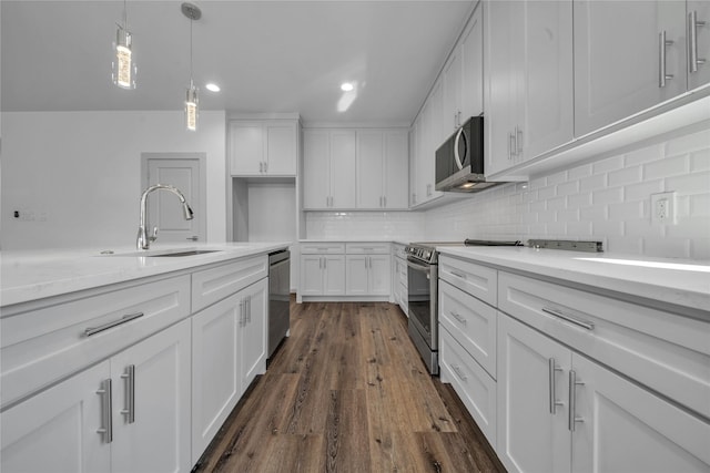 2408 Givendale Rd, Dallas, TX 75241 - kitchen with a sink, appliances with stainless steel finishes, white cabinets, tasteful backsplash, and recessed lighting