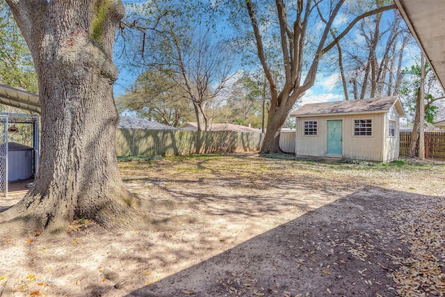 view of yard featuring an outdoor structure and a fenced backyard