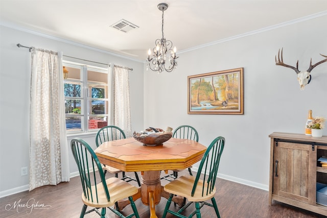 dining room featuring visible vents, baseboards, dark wood finished floors, ornamental molding, and an inviting chandelier