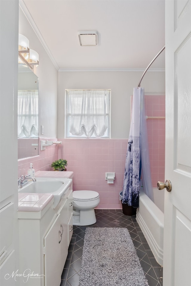 bathroom featuring tile patterned flooring, tile walls, a wealth of natural light, and ornamental molding