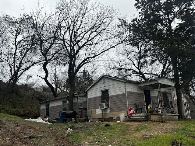 view of home's exterior with cooling unit and covered porch