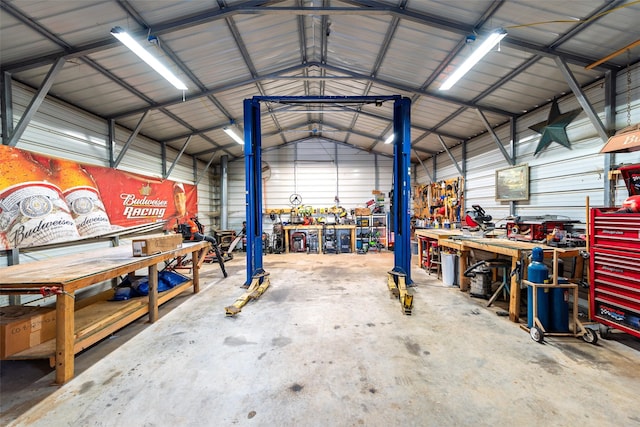 garage featuring a workshop area and metal wall