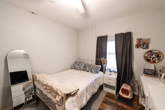 bedroom featuring a ceiling fan and dark wood-style floors