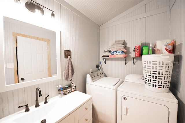 washroom featuring a sink, cabinet space, and washer and clothes dryer