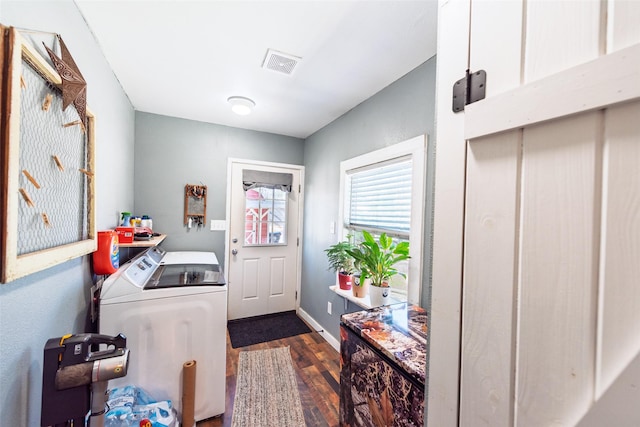 clothes washing area featuring visible vents, baseboards, laundry area, wood finished floors, and separate washer and dryer