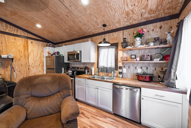 kitchen featuring a sink, butcher block countertops, wood ceiling, and stainless steel appliances