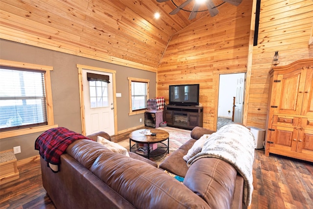 living area with wooden walls, wood finished floors, high vaulted ceiling, ceiling fan, and wood ceiling
