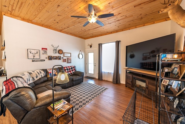 living area featuring a ceiling fan, wood finished floors, crown molding, and wood ceiling