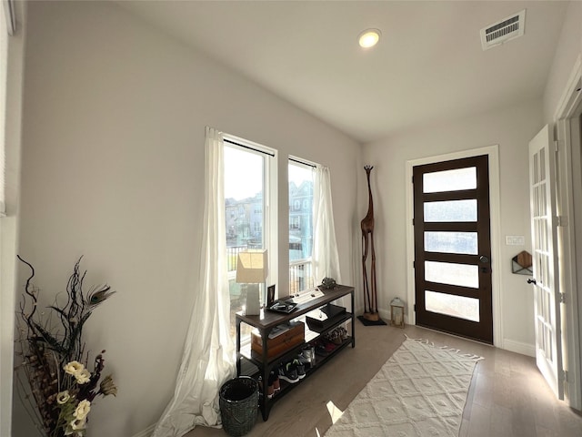 entrance foyer featuring light wood-type flooring and visible vents