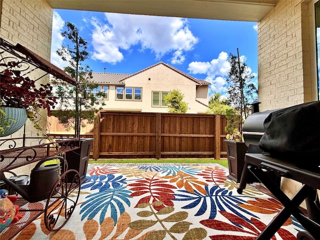 view of patio / terrace with grilling area and fence