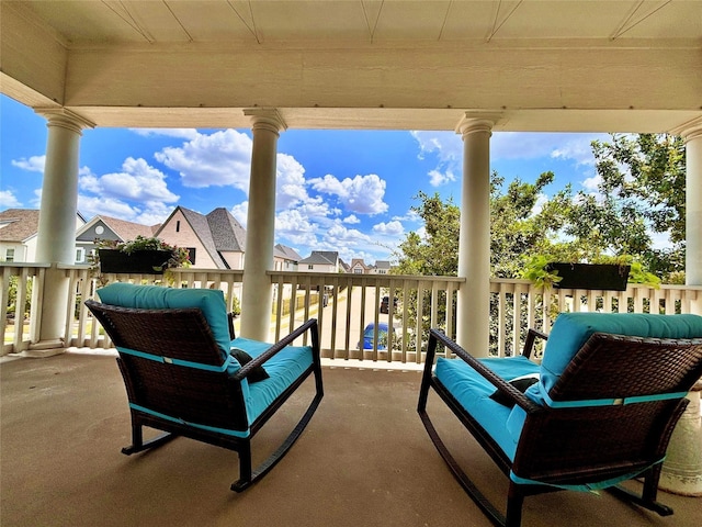 view of patio featuring a balcony and a residential view