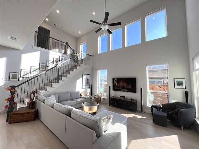 living room featuring wood finished floors, visible vents, and a wealth of natural light