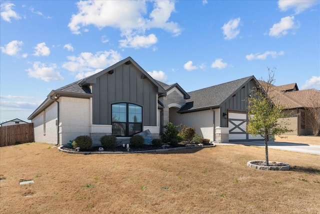 ranch-style house featuring board and batten siding, an attached garage, fence, and driveway