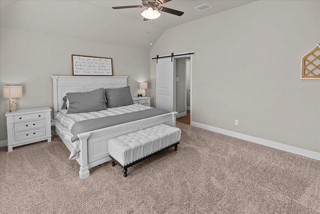 bedroom featuring a barn door, baseboards, lofted ceiling, carpet flooring, and visible vents