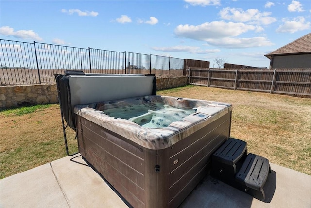 exterior space featuring a fenced backyard and a hot tub