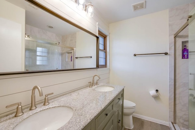 full bath featuring a sink, toilet, and a stall shower