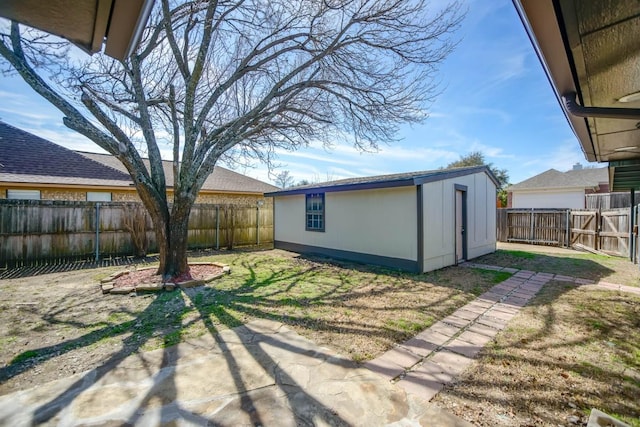 view of yard featuring an outdoor structure and a fenced backyard