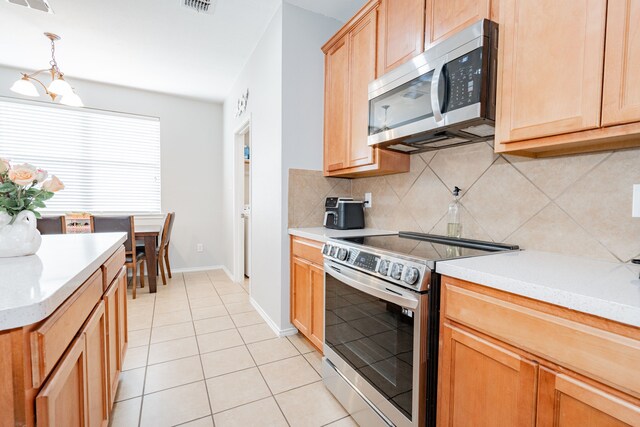 1106 Mule Deer, Forney, TX 75126 - kitchen with light tile patterned floors, backsplash, appliances with stainless steel finishes, and light countertops